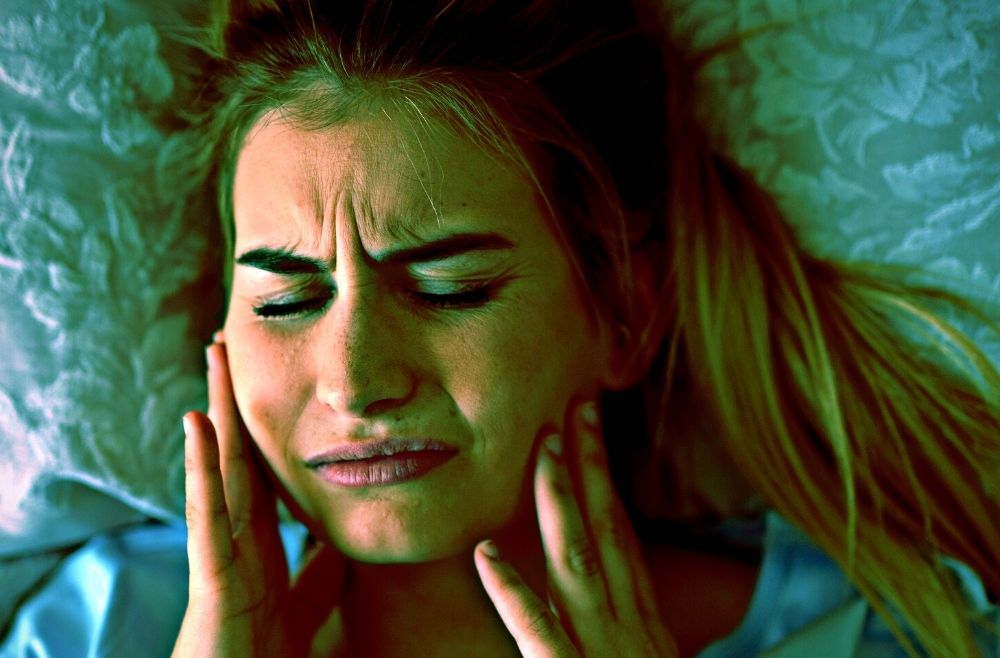 Woman in pain from TMJ
